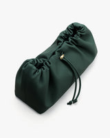 Gathered pouch with drawstring and gold accent.