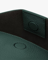Close-up view of a bag's snap button closure and textured interior.