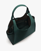 Handbag with wide straps and multiple compartments shown from top angle
