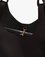 Close-up of a tote bag with a zip closure and handles.