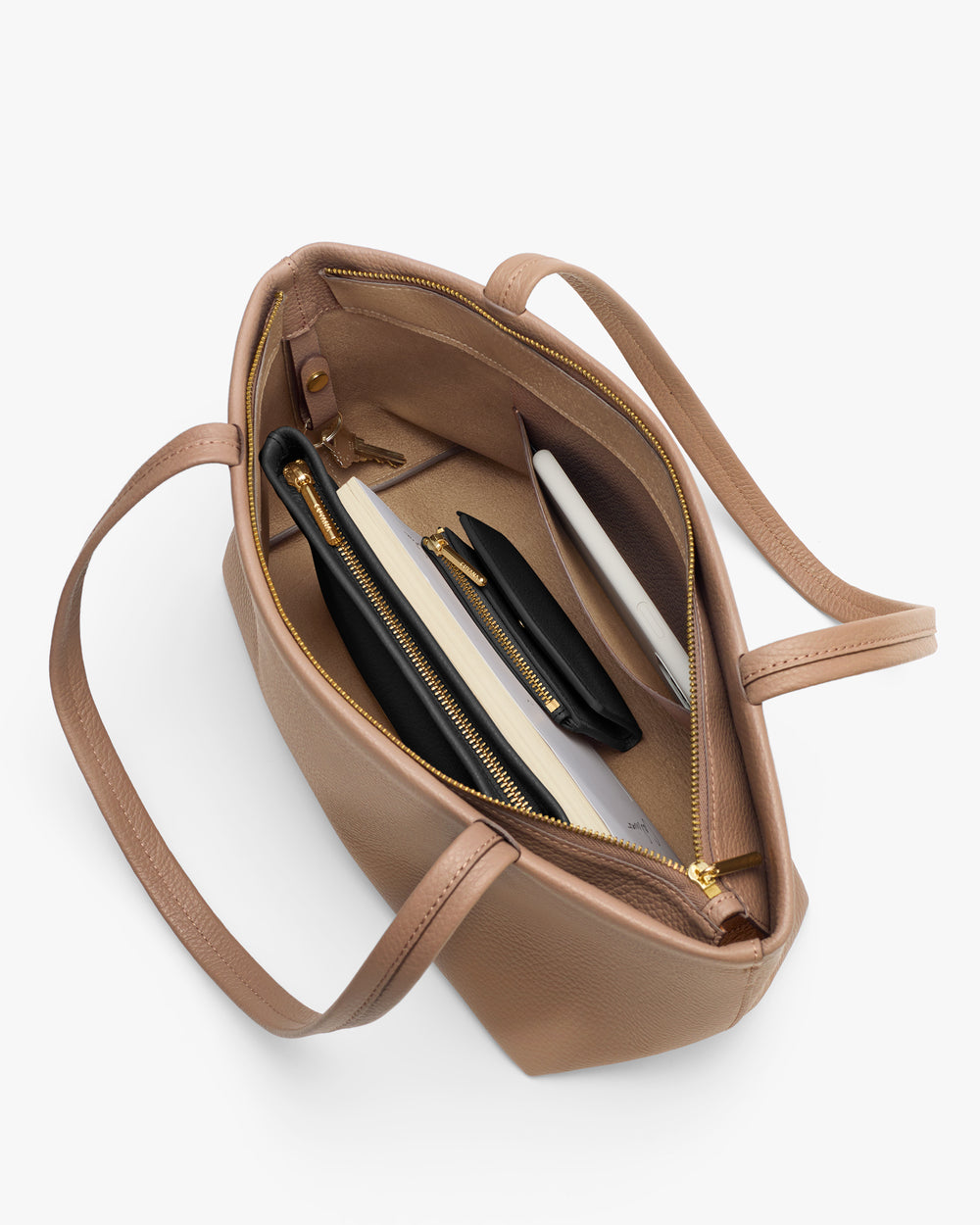 Open handbag with a laptop, notebook, and small pouch inside.