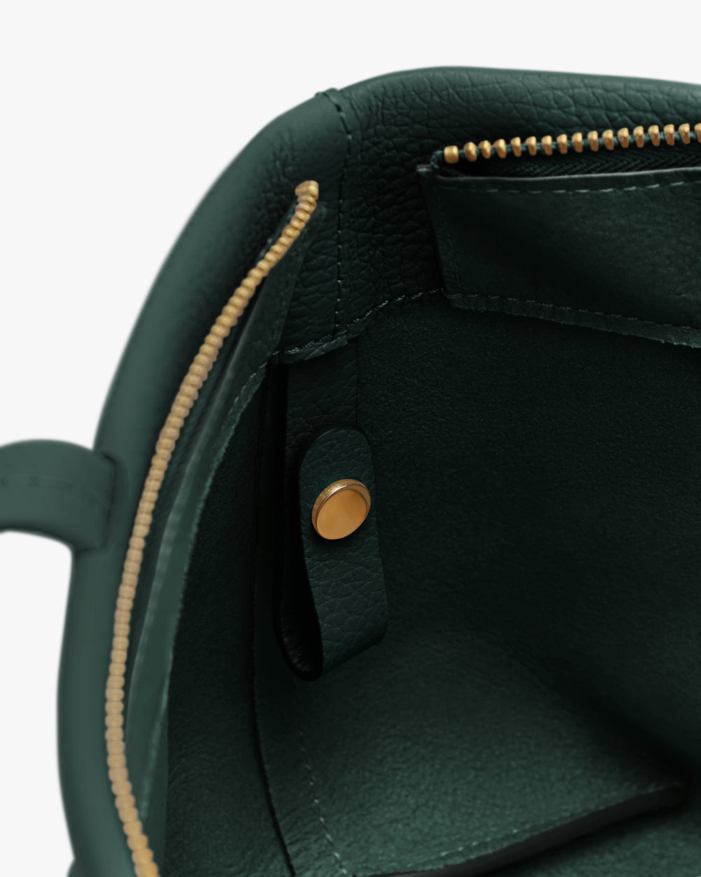 Interior view of a bag with a zipper and snap button.