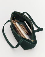 Open tote bag with items including a wallet, notebook, and tablet.