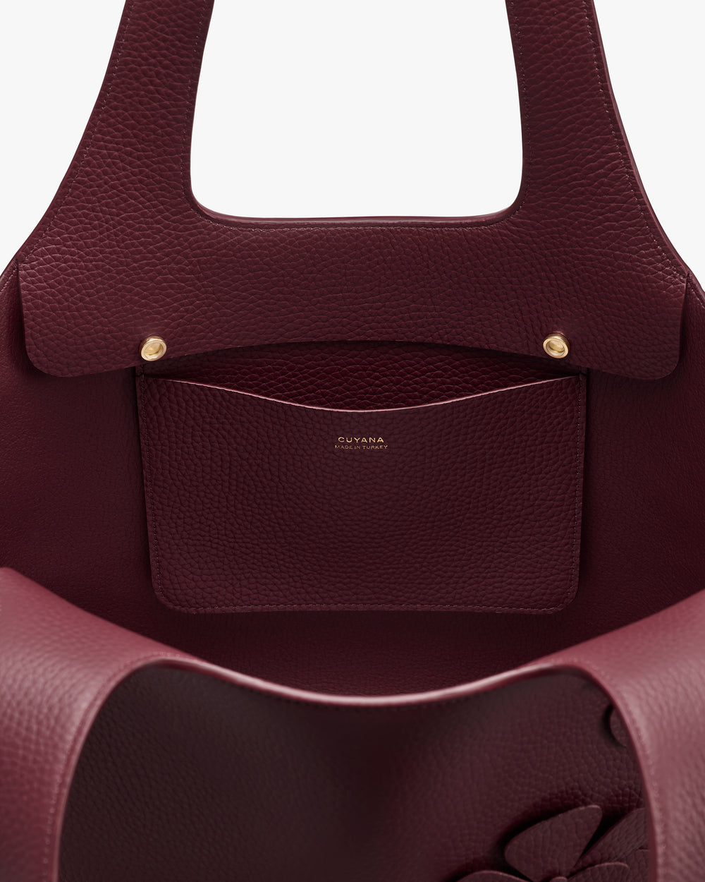 Open handbag showing interior pocket with brand logo.