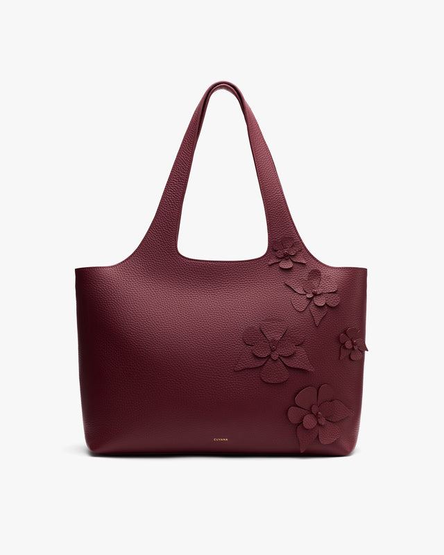 Tote bag with floral embellishments on the front.