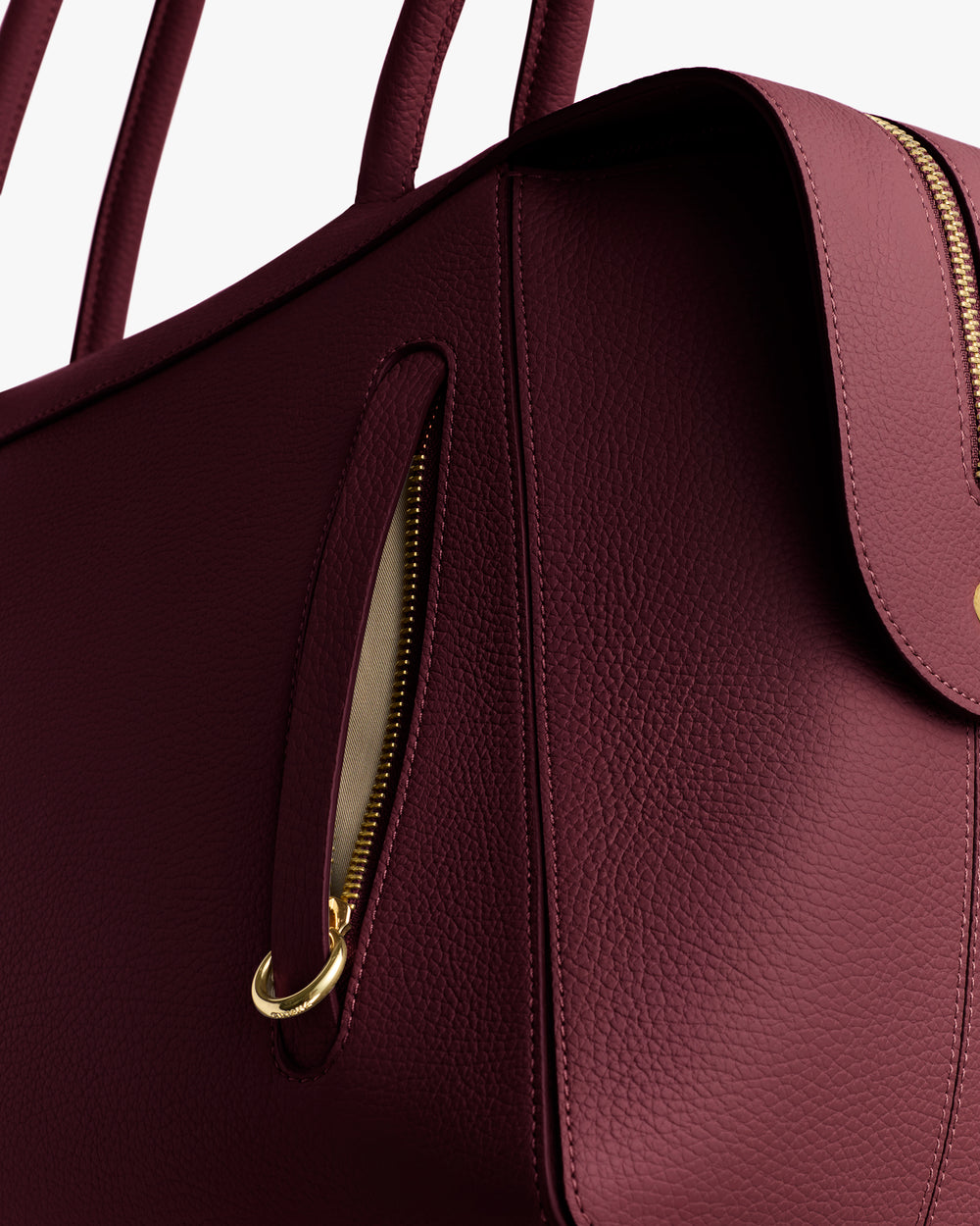 Close-up of a textured handbag with a zipper pocket and strap.