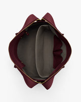 Open travel bag with compartments and zipper closure viewed from above