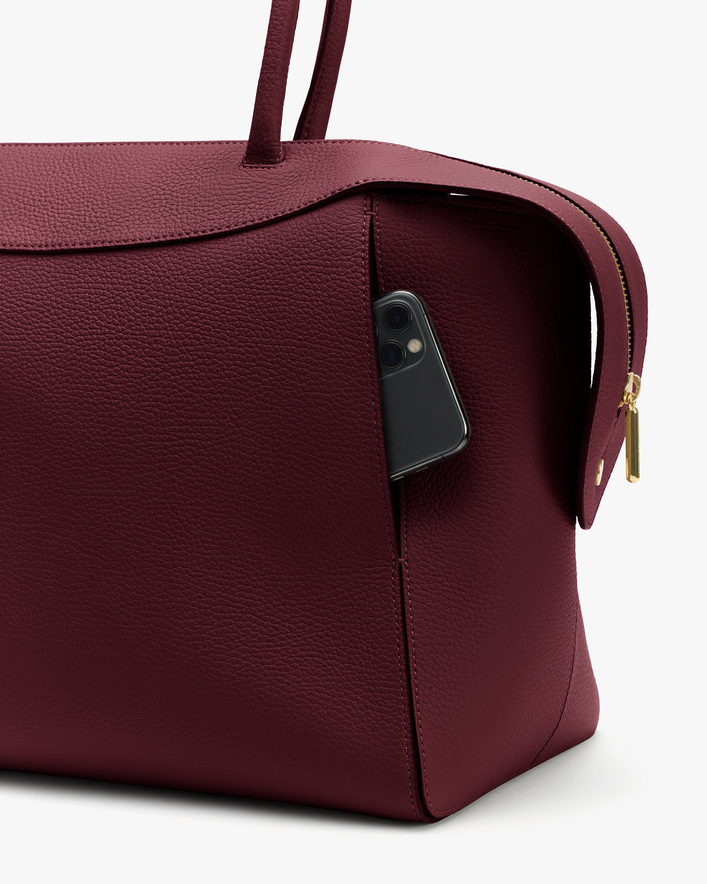Travel bag with a smartphone in the side pocket.