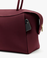 Travel bag with a smartphone in the side pocket.
