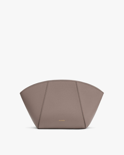 Handbag with arch shape and small logo.