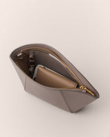 Open handbag containing a wallet and phone.