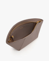 Open purse with a central zipper and interior pocket.