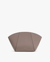 Handbag with arch shape and small logo.