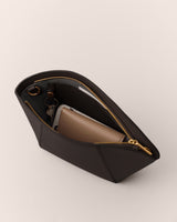 Open handbag with a zipper, revealing a wallet and a phone inside.