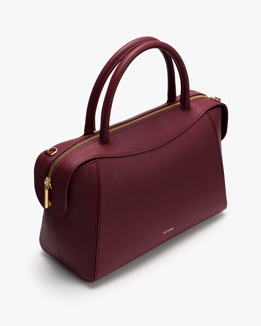 Handbag with two handles and a zipper on top.