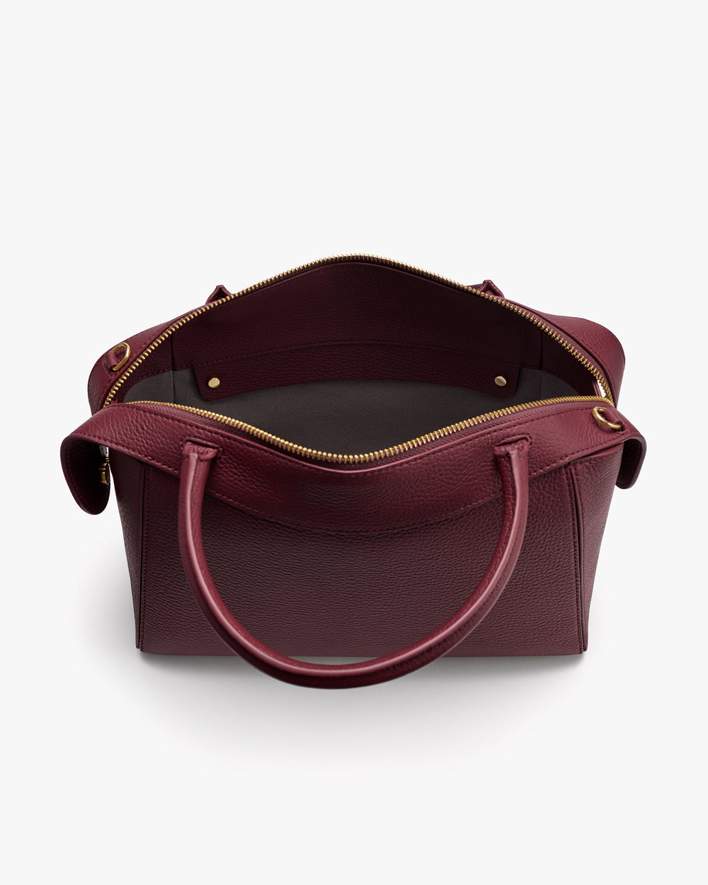 Open handbag with two handles and a zippered top, showing interior space.