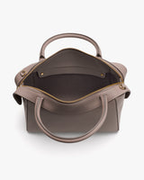 Open handbag with two handles and a zippered compartment.