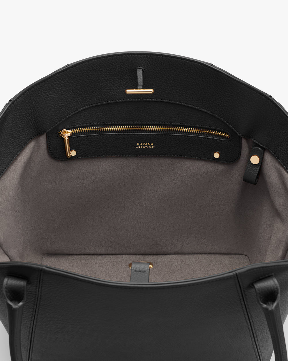 Open bag interior with a zippered pocket and handles.