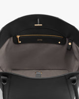 Open bag interior with a zippered pocket and handles.