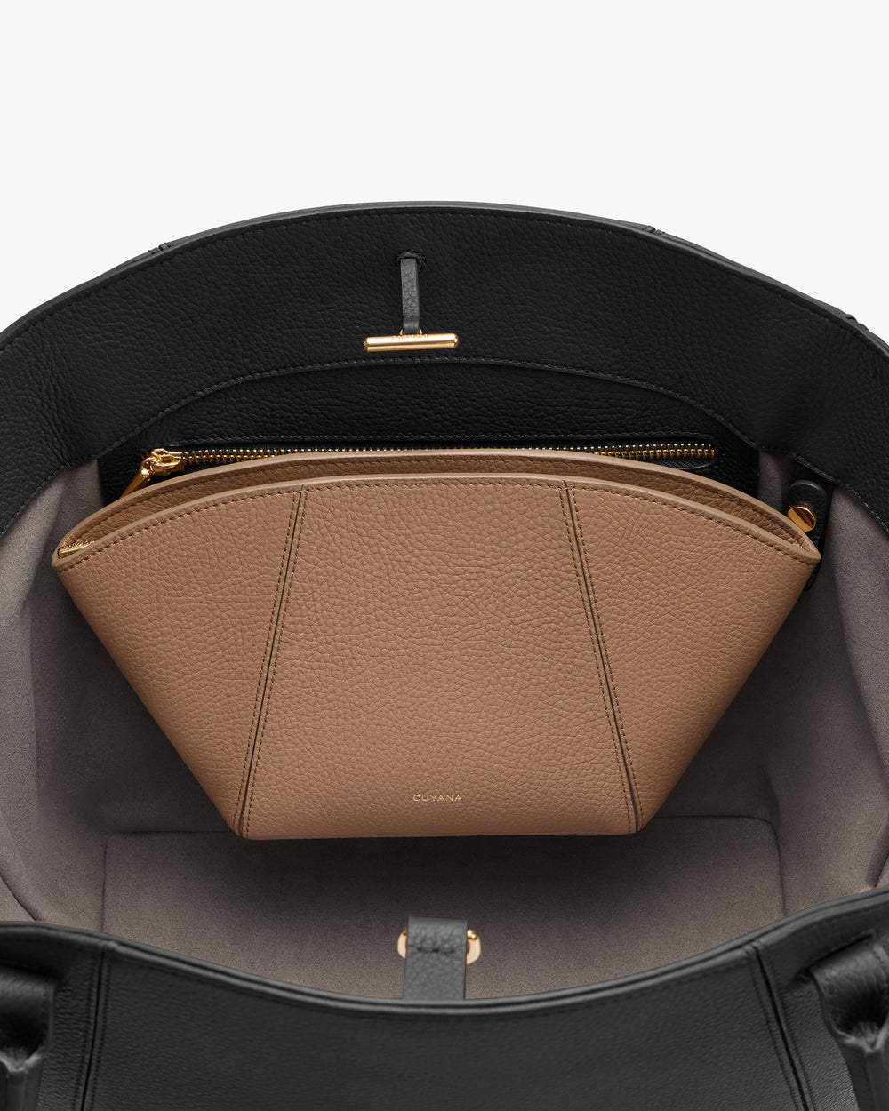 Open handbag with an inner zip compartment and a pouch inside.