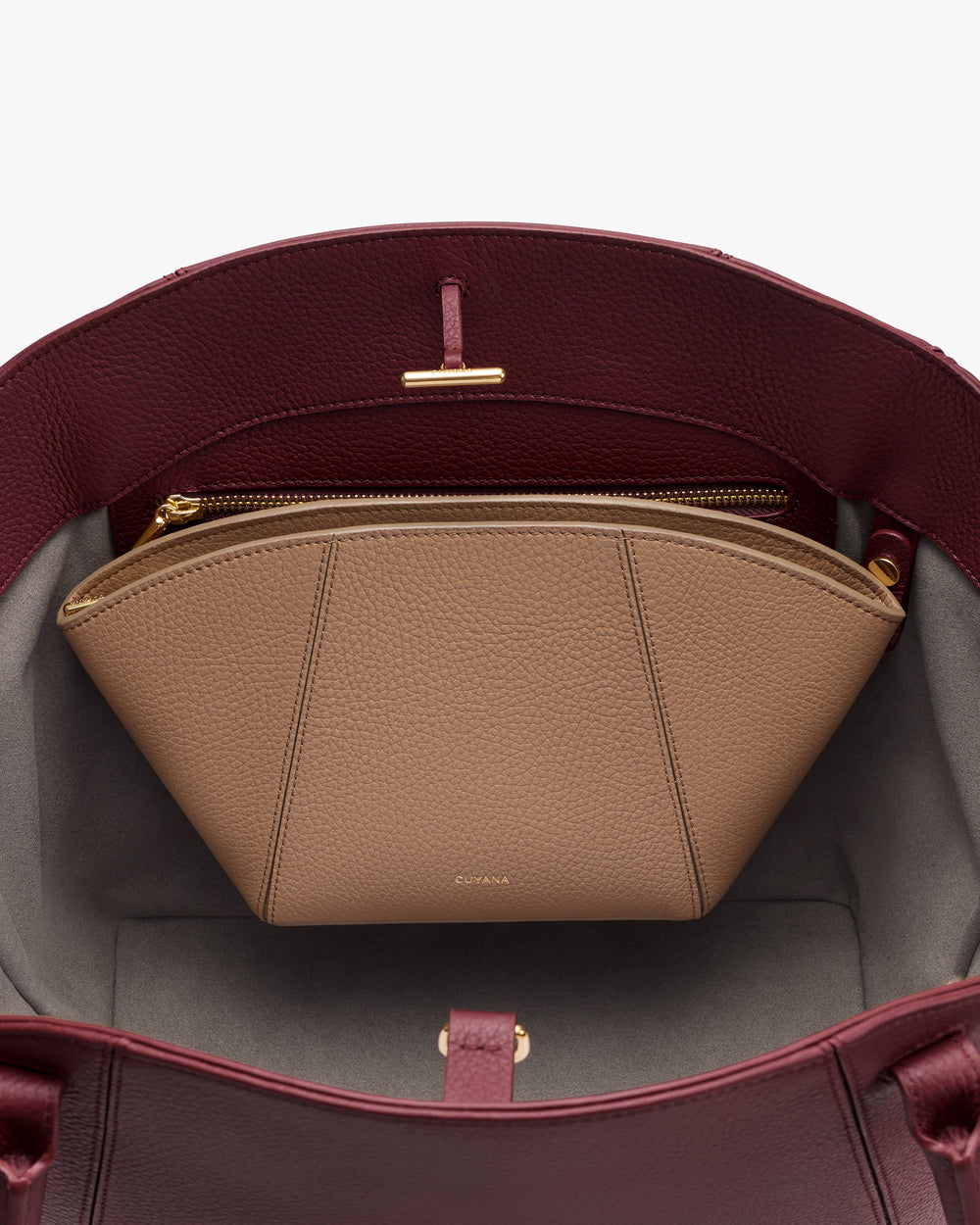 Open handbag showing a zippered pouch inside.