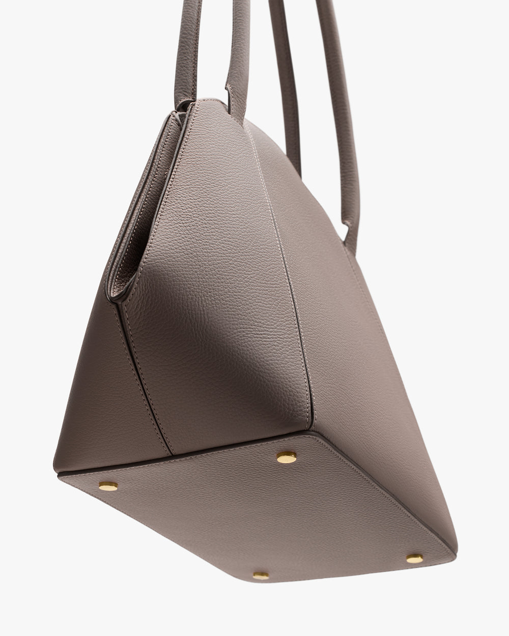 Handbag with four metal feet and two handles.