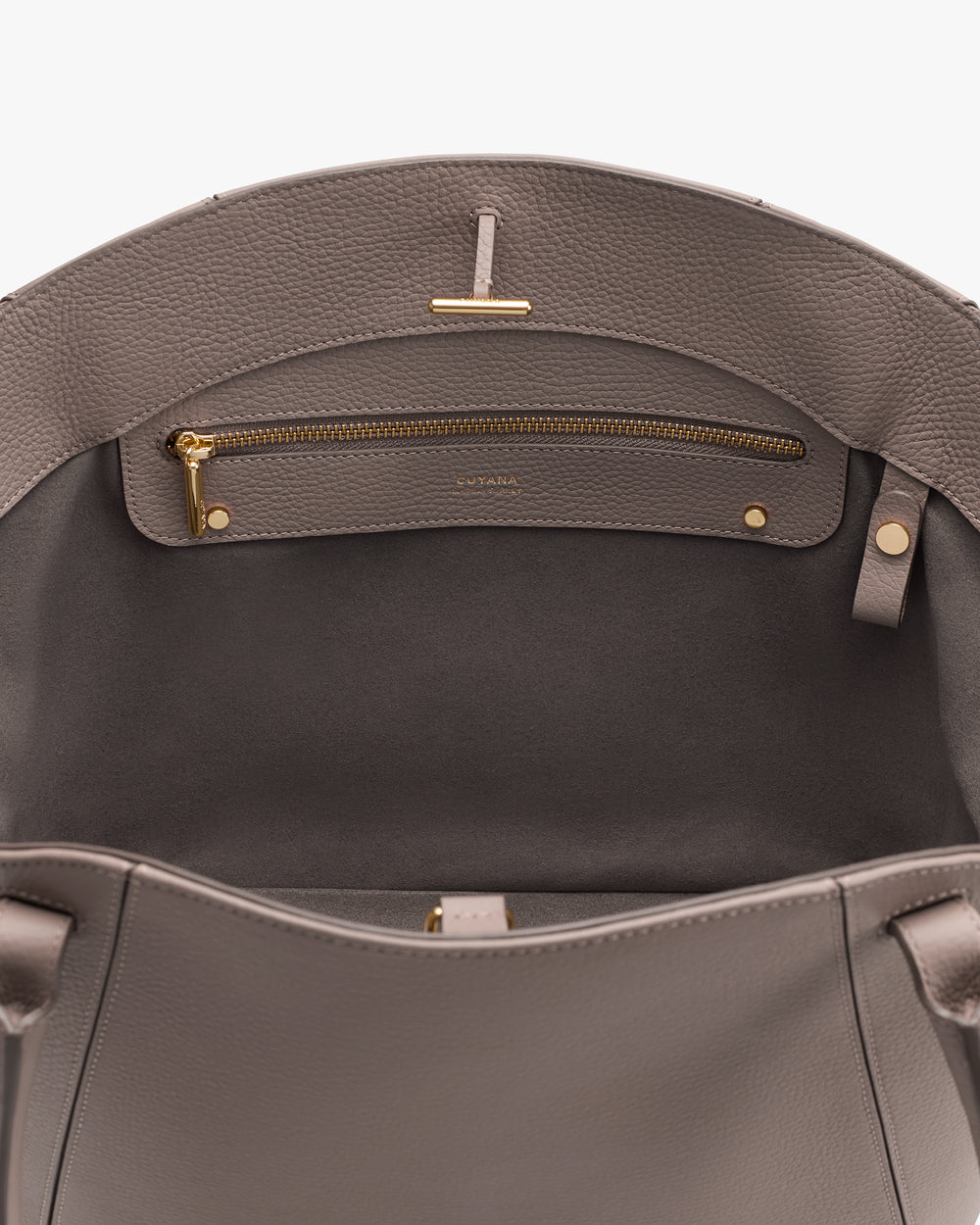 Open handbag showing zipper pocket inside.