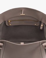 Open handbag showing zipper pocket inside.
