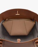 Open handbag showing a zippered pouch inside.