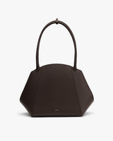 Geometric handbag with curved handles.