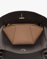 Open handbag with zippered pouch inside.