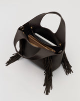 Open handbag with two purses and fringe detail on the side.