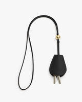 Key holder with long strap and metal key inserts.