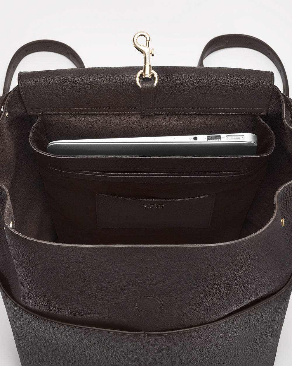 Open bag with laptop inside and a small clasp at the top.