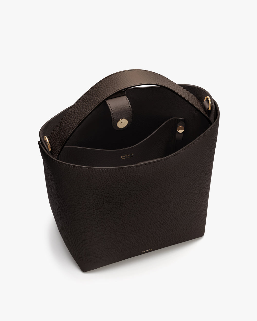 A handbag with an open top and strap shown from above.
