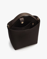 A handbag with an open top and strap shown from above.