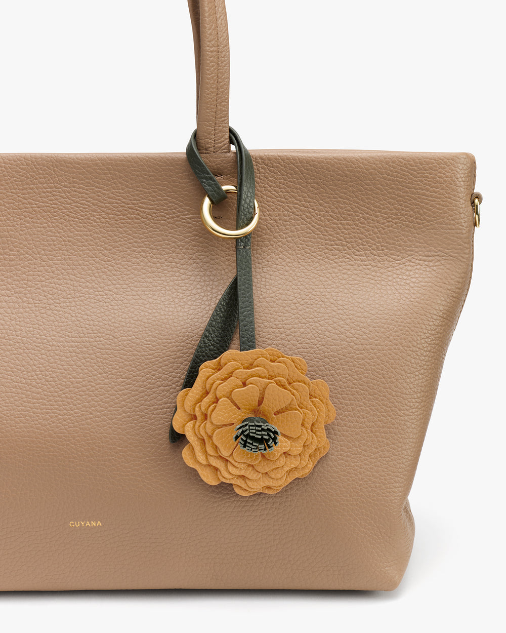 Tote bag with a floral charm attached to the handle