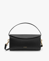 Handbag with a curved handle and detachable strap.