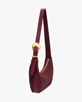 Shoulder bag with curved shape and zipper closure