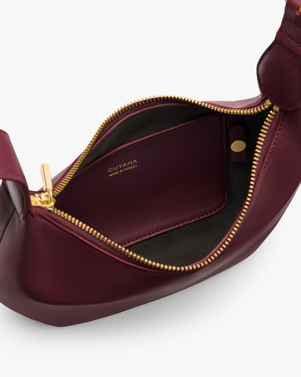 Open leather handbag with visible interior and zipper.