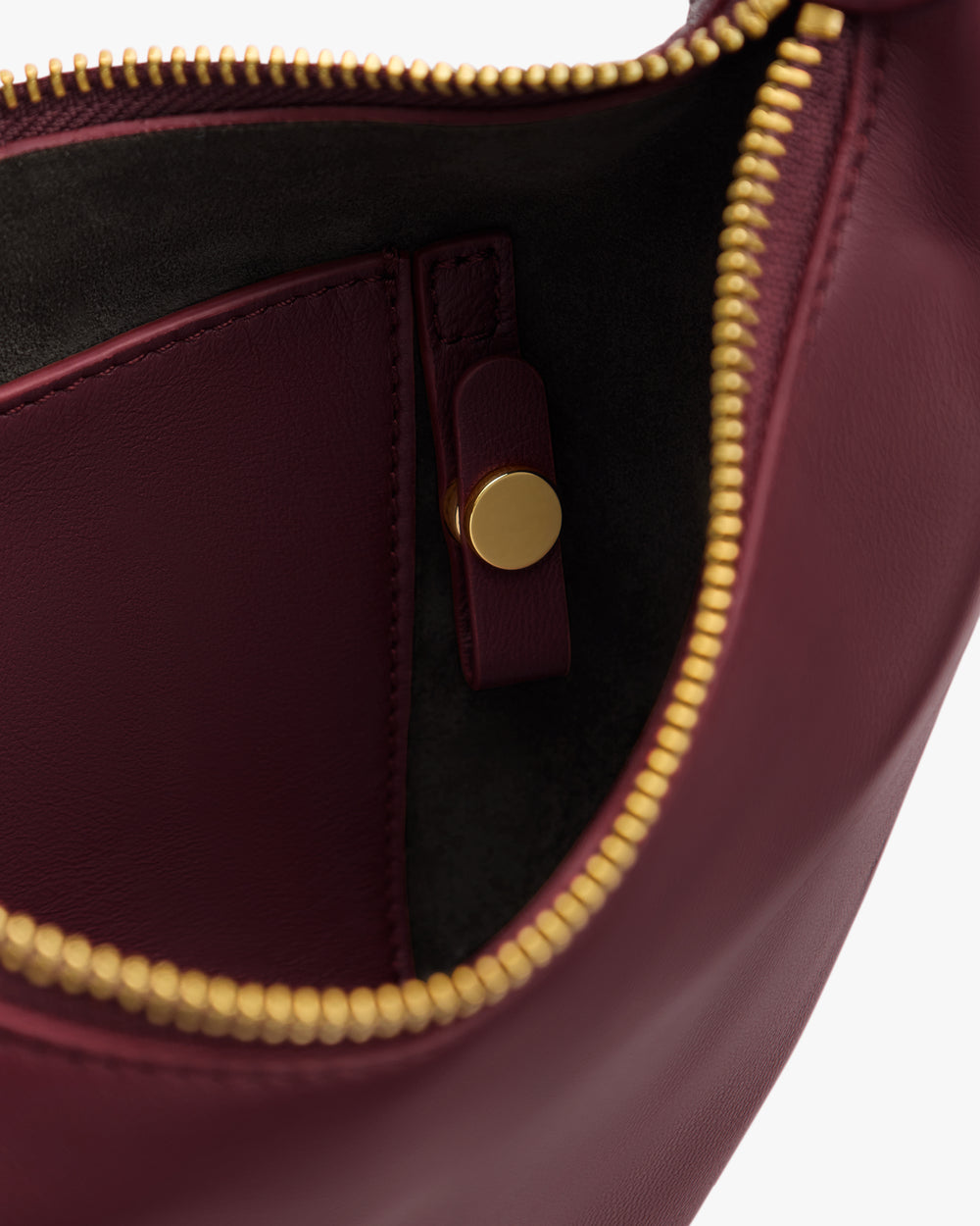 Open bag showcasing interior with pocket and zipper.