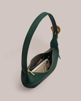 Handbag with an open zipper showcasing its contents, including a wallet and a smartphone.