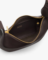 Open handbag with visible zipper and interior compartment.