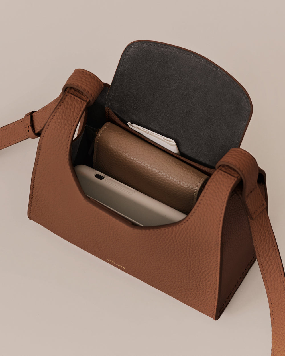 Open handbag showing wallet and smartphone inside