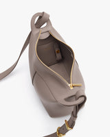 Open handbag with visible zipper, strap, and interior pocket.