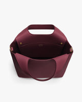 Open handbag with rounded handles and visible interior pocket.