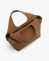 Handbag with unique cutout handle design viewed from an angle.
