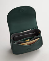 Open handbag showing compartments with items inside