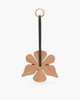 Flower-shaped leather charm with strap and metal ring.