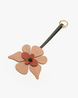 Flower-shaped keychain with a loop strap and metal ring.